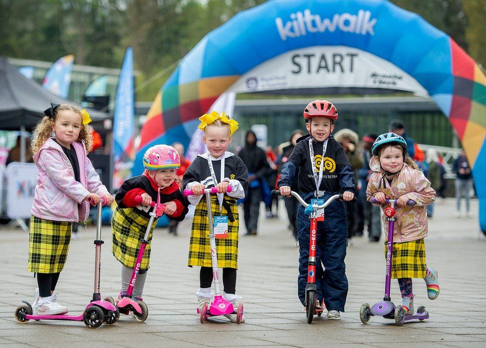 children on scooters during kiltwalk